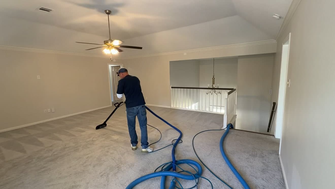 A Gen 2 Cleaners technician steam cleaning a carpet