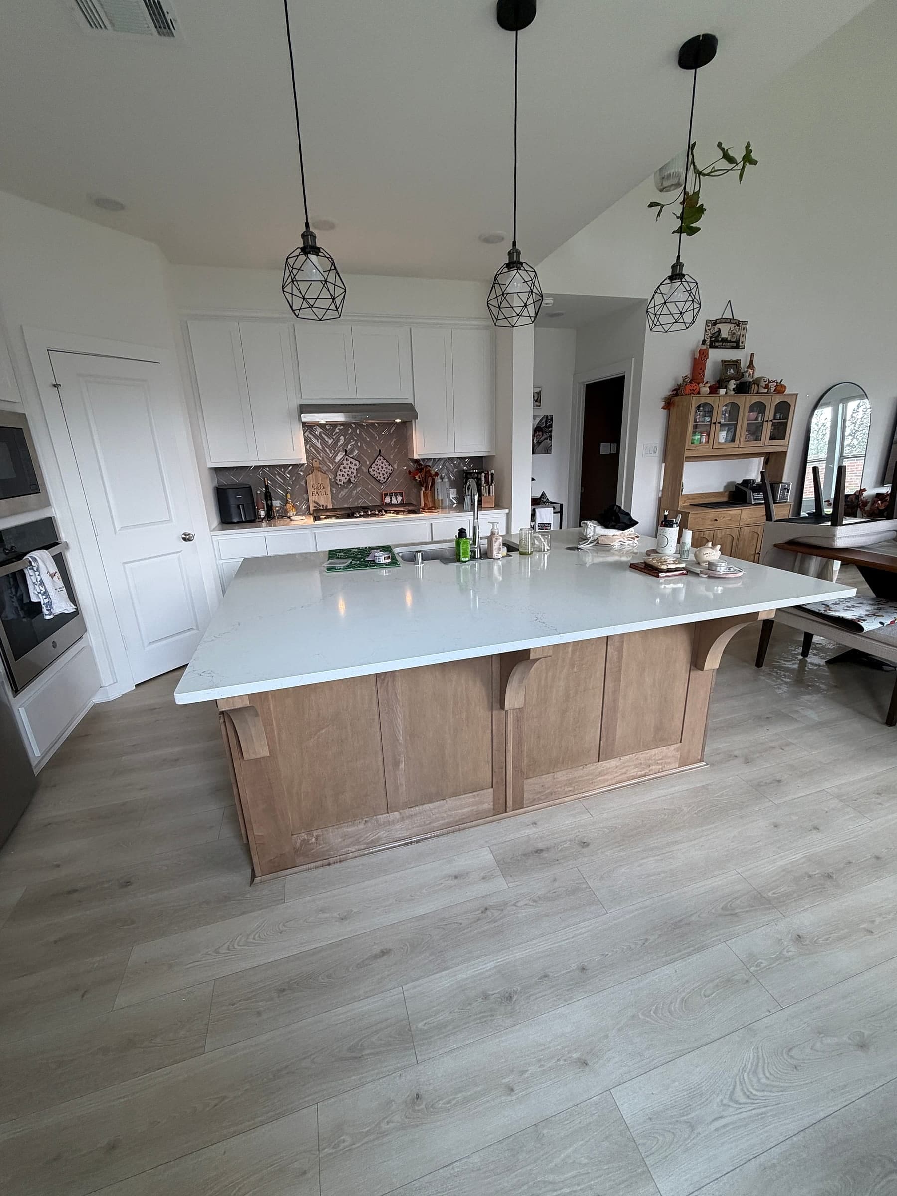 Bright kitchen with a large wood island in a Gen 2 Cleaners client's home