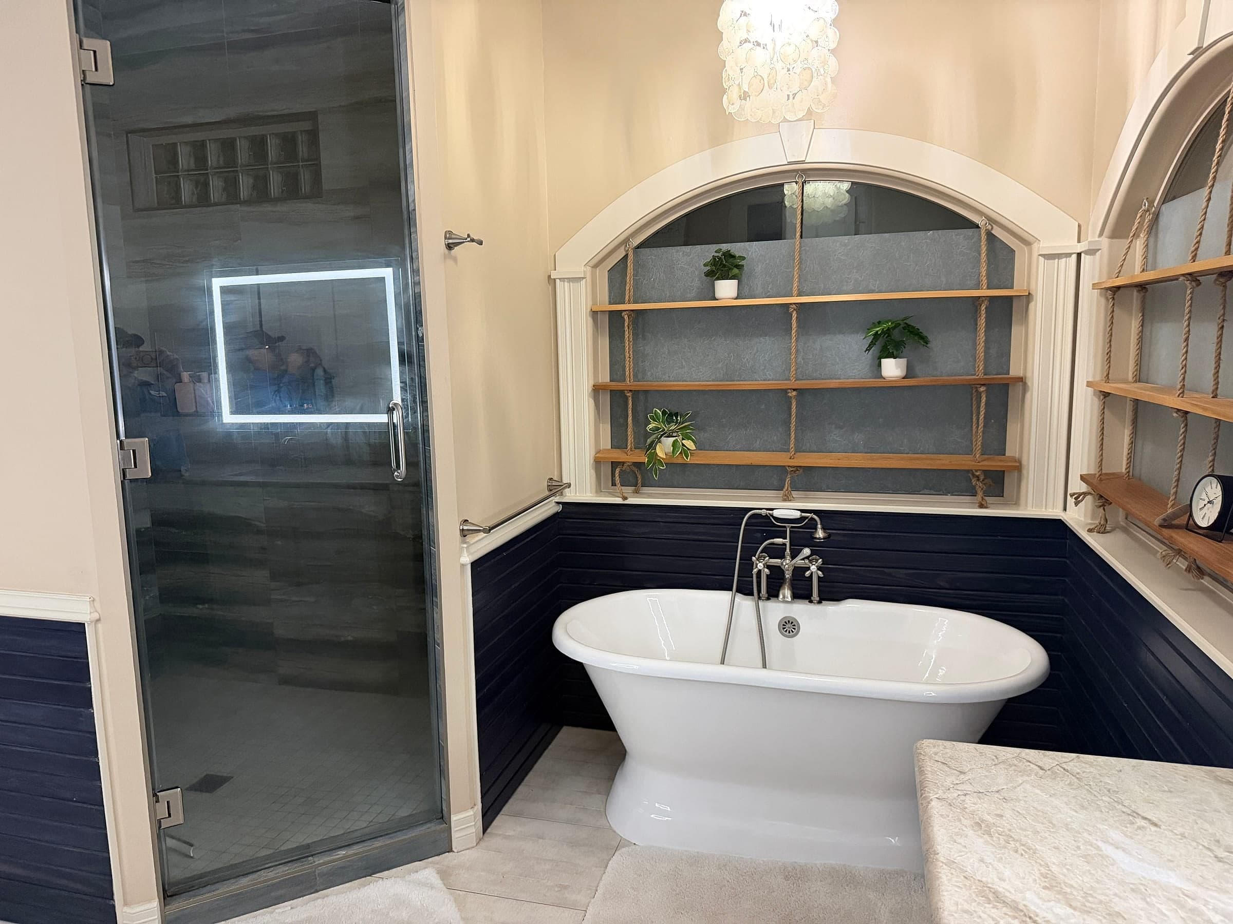 Spa-style primary bathroom with a soaking tub and glass shower